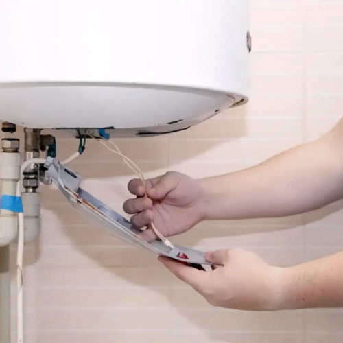A plumber installing a water heater